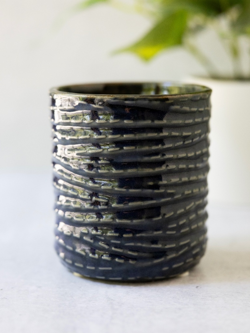 Dark blue ceramic planter with faux gray stitching made in China 3.75" tall